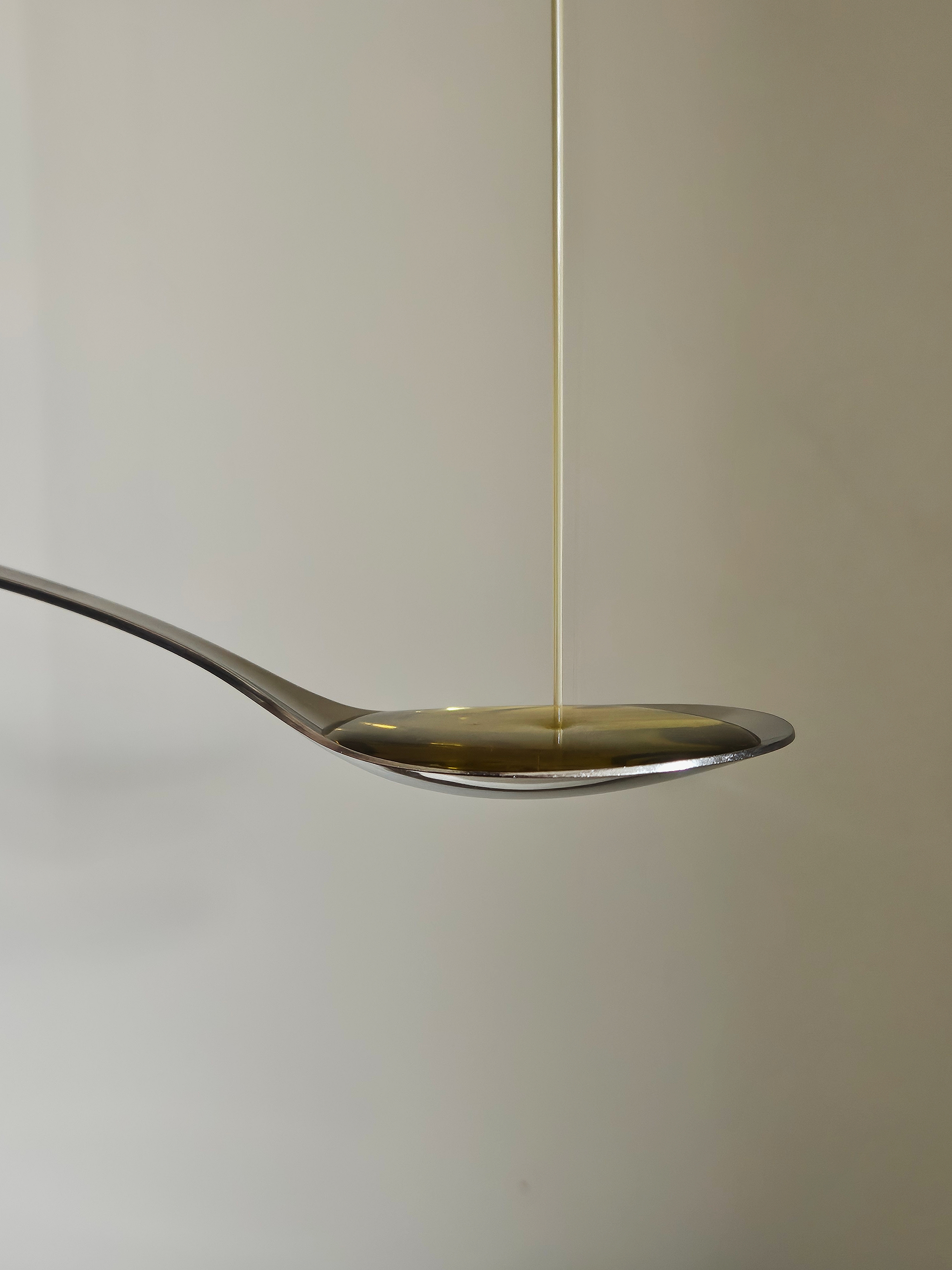 Sciopetta extra virgin olive oil poured onto a spoon